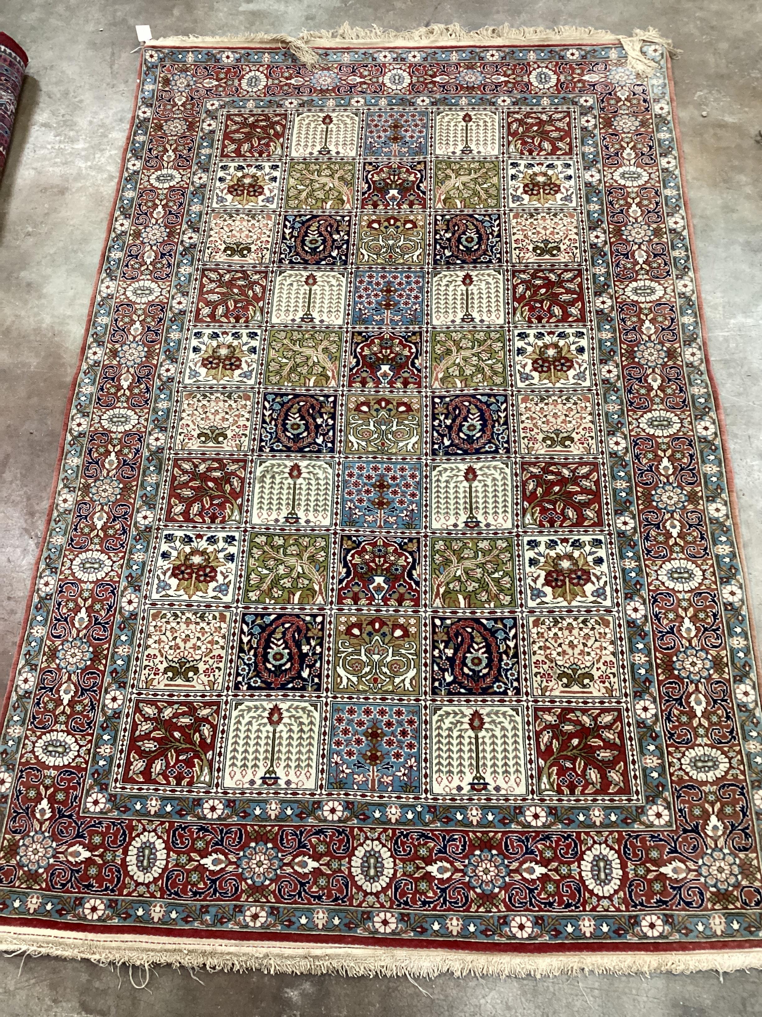 A Baktiari cream ground rug with divided field and triple border, 215 x 136cm